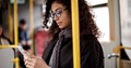 woman on bus checking phone